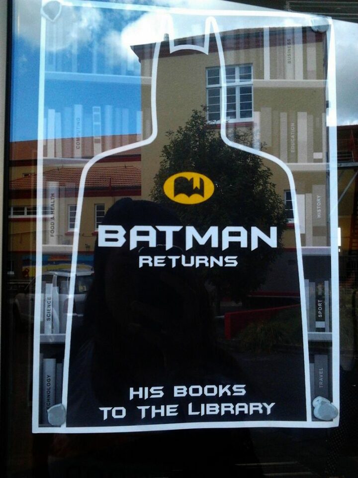 "Batman returns his books to the library."